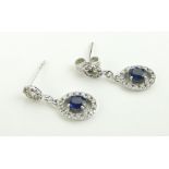 Pair of 18ct white gold sapphire and diamond pendant earrings, length 17mm.