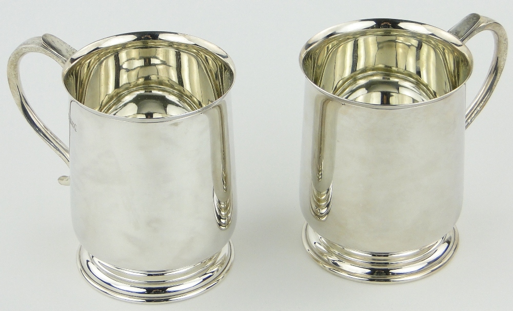 A pair of modern silver pint mugs by Cooper Bros.
23.5oz total.