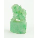 A Chinese carved green jade miniature dragon, height 25mm.