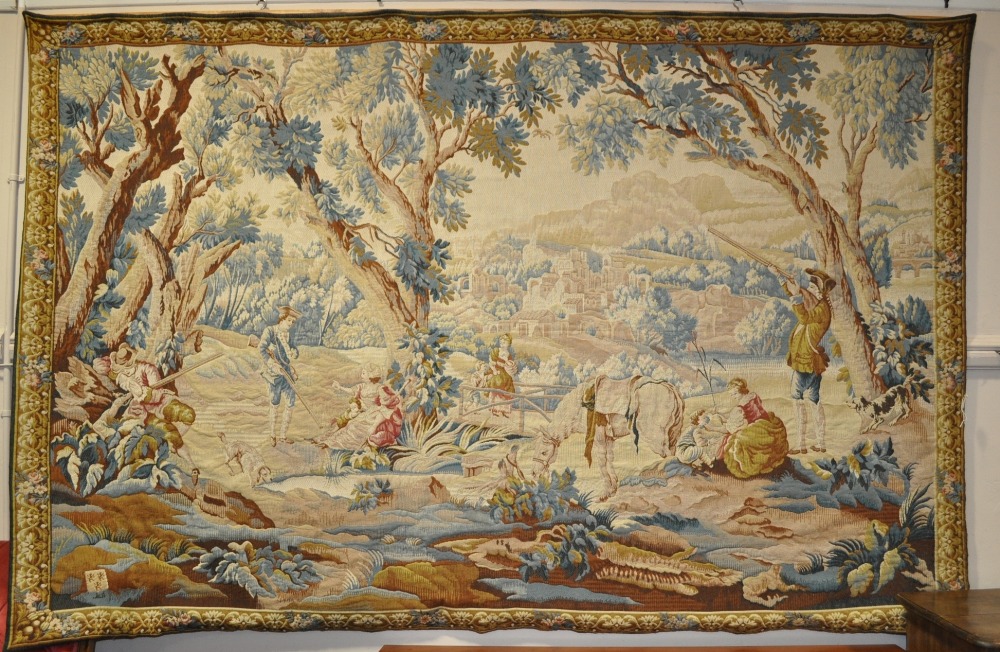 A large machine made tapestry depicting a country hunting scene,
9' x 6'.