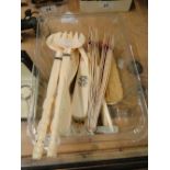 Ivory brush set, glove stretcher, salad server, bone fan, mother of pearl spoons and knives.