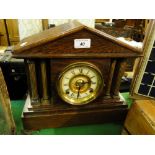 An oak architectural design mantel clock with 2-train movement.