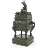 An Oriental bronze koro & cover
with fish finial and elephant head handles.