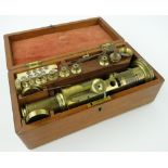 A 19th century brass barrel microscope
with accessories and ivory slides, dated 1834,