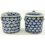 A pair of Antique Oriental blue and white containers and covers,
diameter 7.5".