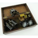 A pair of marine/opera glasses,
military binoculars and another pair, etc., in mahogany case.