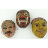 A carved and painted wood mask
with yellow face, height 8.5" and 2 other painted tribal masks, (3).