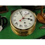 A brass ships clock by Charles Frodsham, 
London, diameter 8" overall.