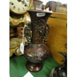 An Oriental bronze vase with embossed birds and foliage.