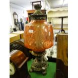 A German cast brass table lamp with pink glass shade.