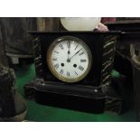 A 2-train mantel clock and a brass oil lamp.