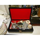 A leather jewel box and a quantity of costume jewellery including a coral necklace, etc.