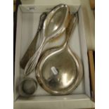 A silver backed dressing table brush and mirror, silver handled shoe horn and a napkin ring.