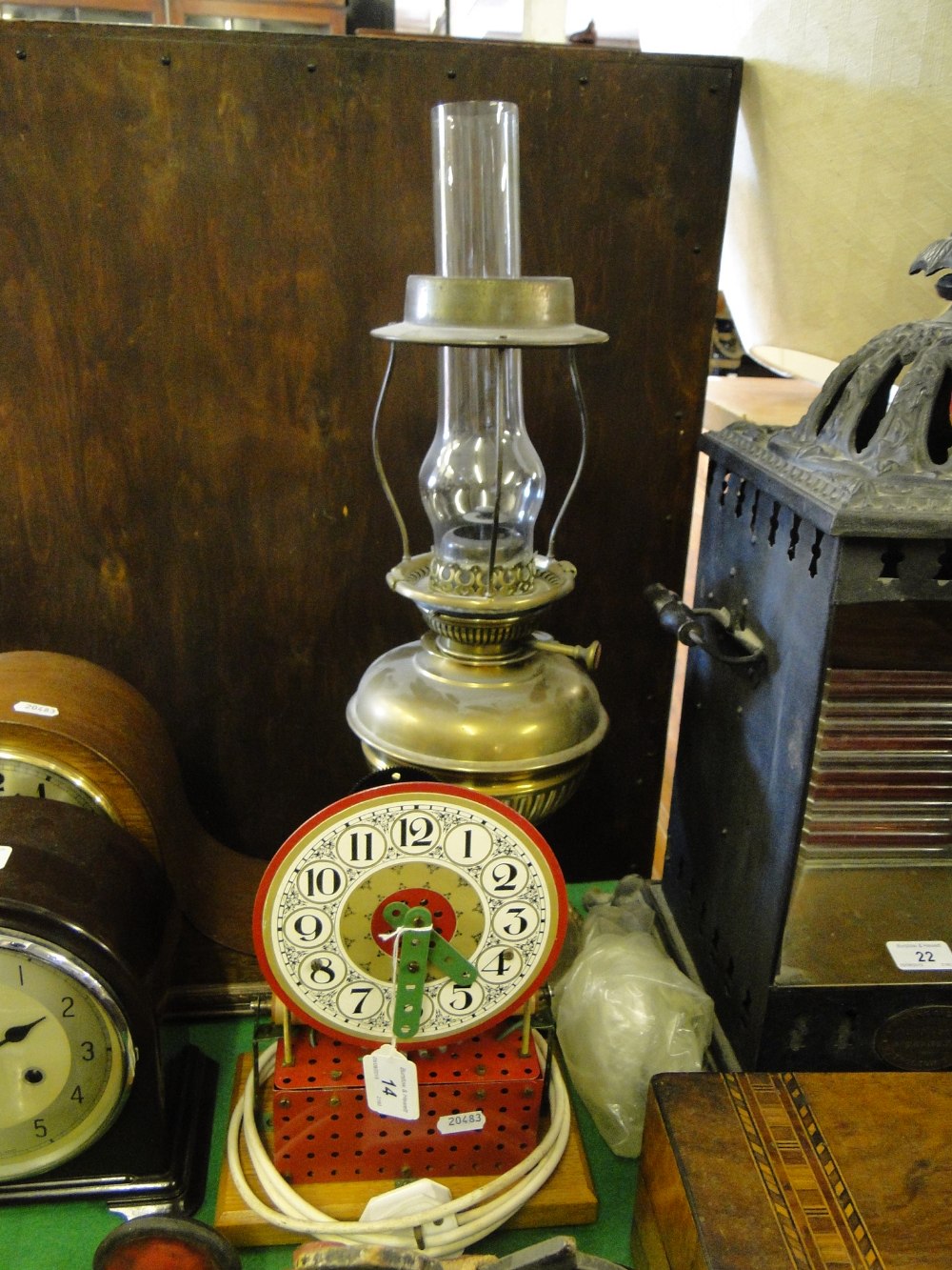 A Meccano clock and an oil lamp.