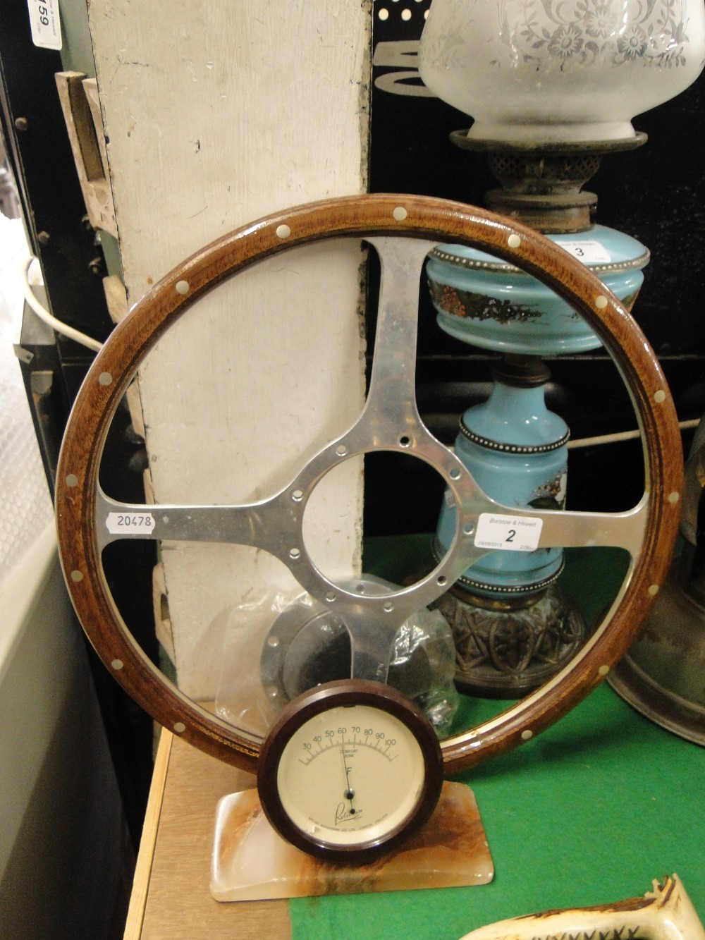 Wood rim steering wheel and a thermometer.