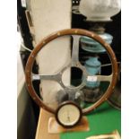 Wood rim steering wheel and a thermometer.