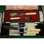 A cased fish cutlery set for 6 people and 2 cased sets of servers.