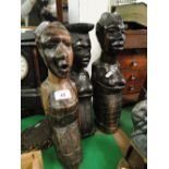 3 carved tribal figures and a bell.