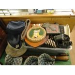 A Commandos woolly hat, RAF caps, a pith helmet, binoculars, truncheon and other military items.