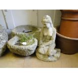 A garden stoneware figure, and a stoneware garden tree trunk design planter.