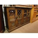 A low oak cabinet with 4 lead light glazed doors.