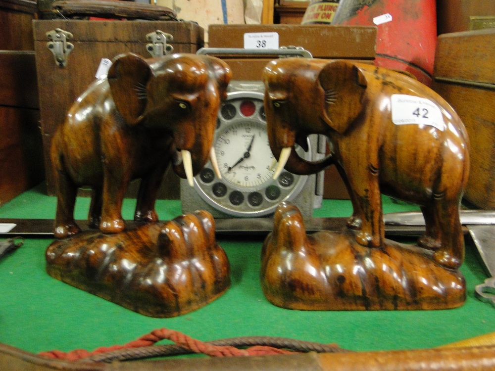 A pair of carved wood elephants.