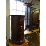 A hardwood drum design 3 -drawer chest and jardiniere stand.