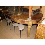 An Edwardian mahogany oval wind-out dining table, with carved edge,