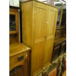 An oak 2-door school shoe cupboard.