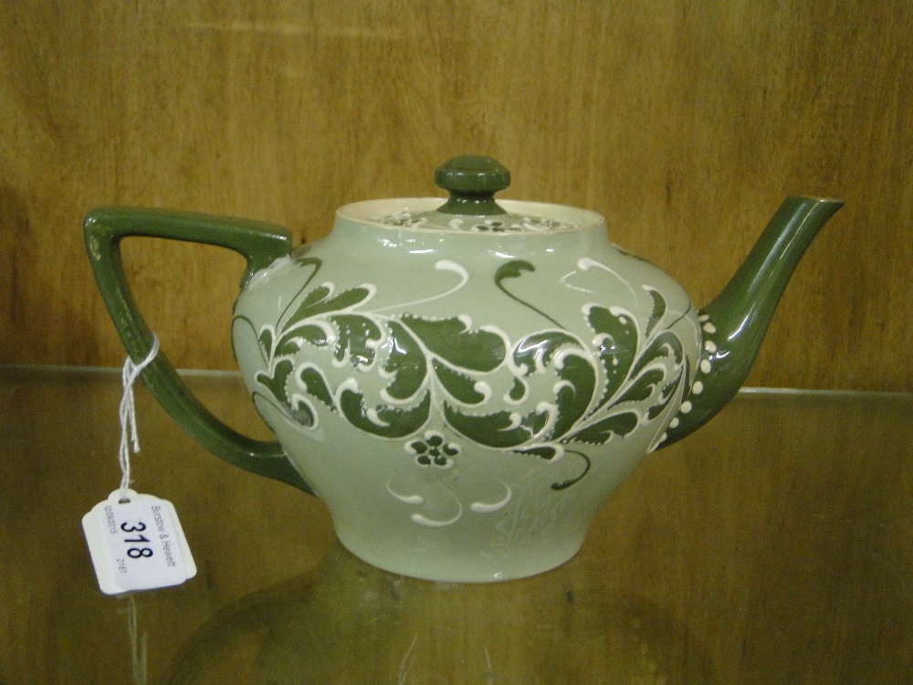 An early MacIntyre's/Moorcroft Gesso Faience teapot
with enamelled foliate decoration, height 5".