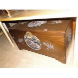 An Oriental carved camphor wood blanket chest.