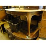 A French oak oval extending dining table on cabriole legs.