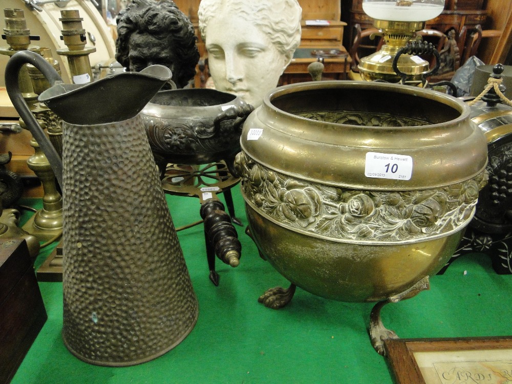 A brass jardiniere, copper bowl and hot water jug, and a brass trivet.