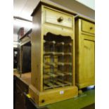 A small pine wine rack with drawer.