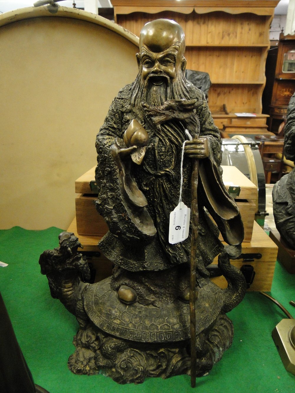 An Oriental bronze depicting a sage on a mythical beast.