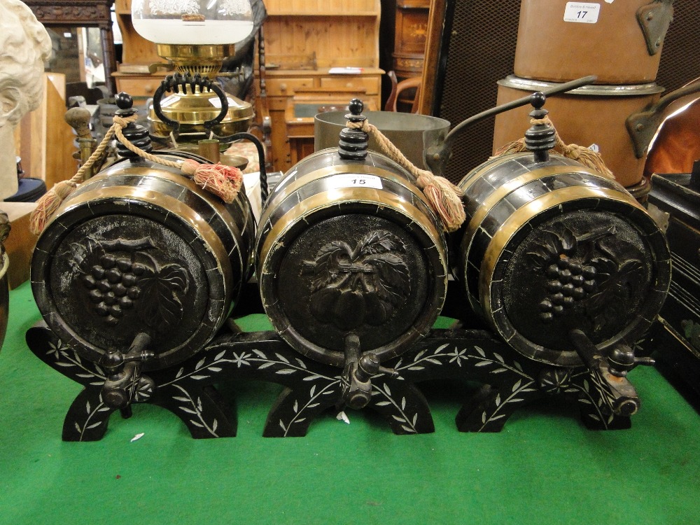 A set of 3 brass bound coopered barrels on stand.