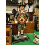 A Clock with painted metal figure support
