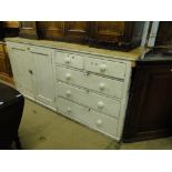 A large Victorian painted pine dresser base, with fitted cupboards and drawers.