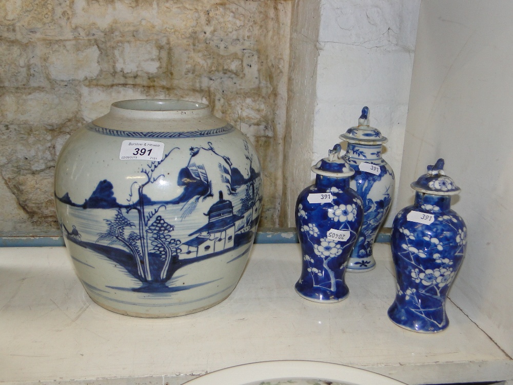A pair of Chinese porcelain jars and covers
with prunus decoration, 6.