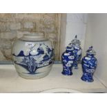 A pair of Chinese porcelain jars and covers
with prunus decoration, 6.