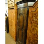 A 1920s floor standing panelled oak corner cupboard with single door.