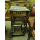 A French carved oak and marble top pot cupboard with turned legs.