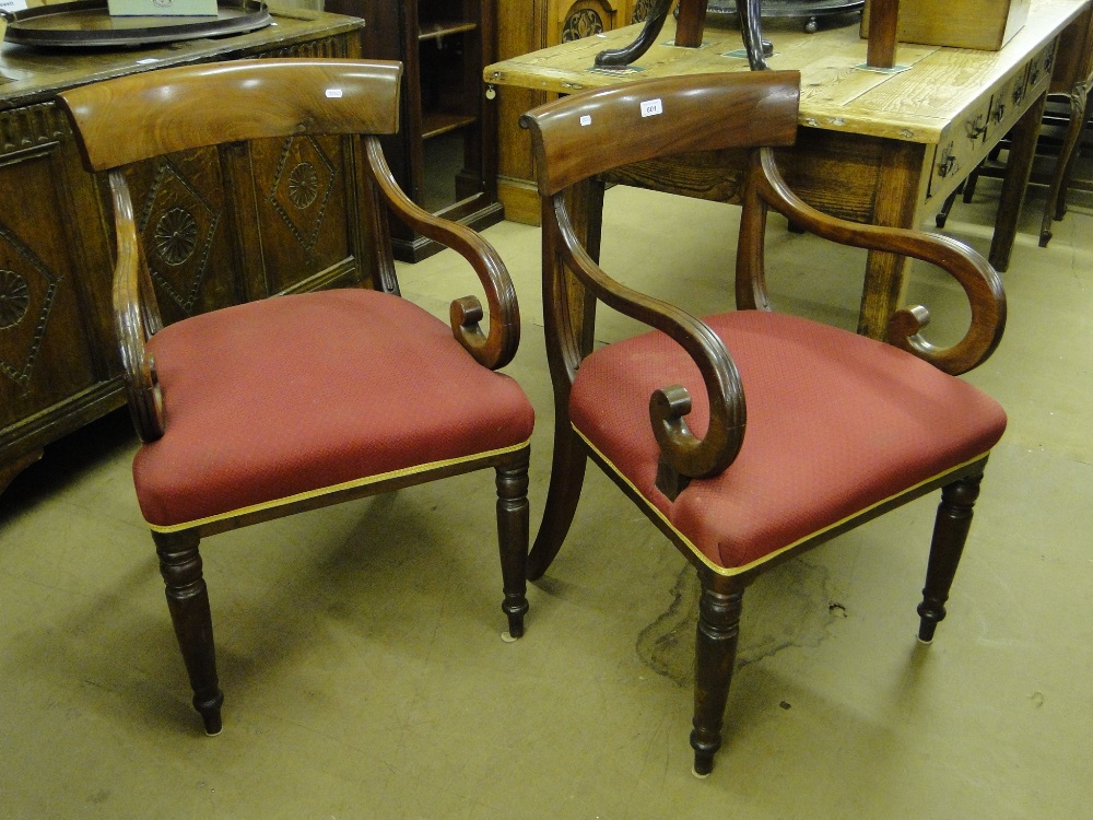 A pair of 19th century mahogany elbow chairs, upholstered seats and turned legs.