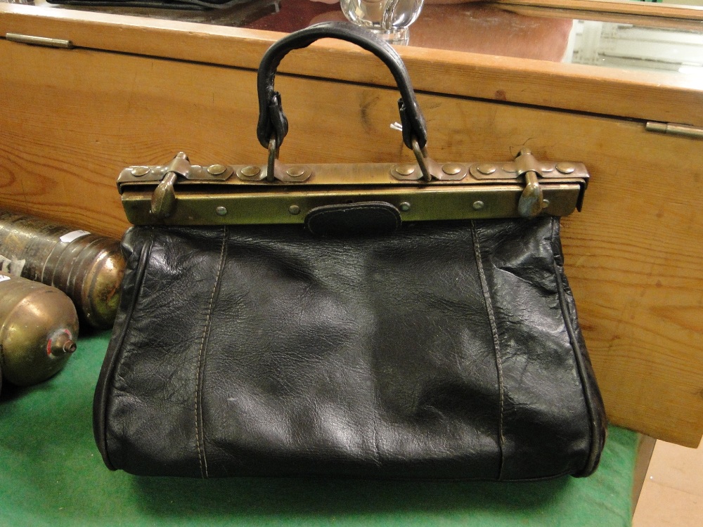 A lady's black leather Gladstone bag.