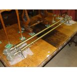 2 Brass curtain poles having blown glass finials,