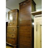 A tall 1920s oak filing cabinet with tambour front.