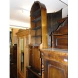 An oak dome top open bookcase with cupboards to the base.