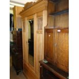 An Edwardian ash single mirror door wardrobe with drawer to the base.