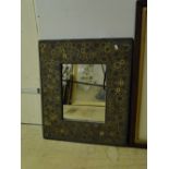 A composite wall mirror inset with circular decoration.