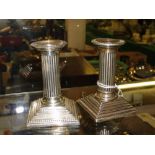 Pair of silver Corinthian column candlesticks, height 10 cms.